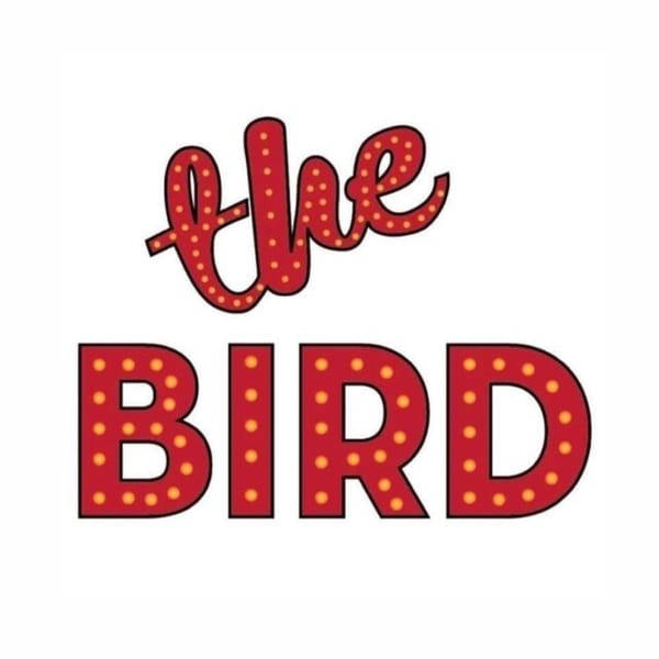 The Bird restaurant logo with red marquee-style letters and yellow lights on a white background.